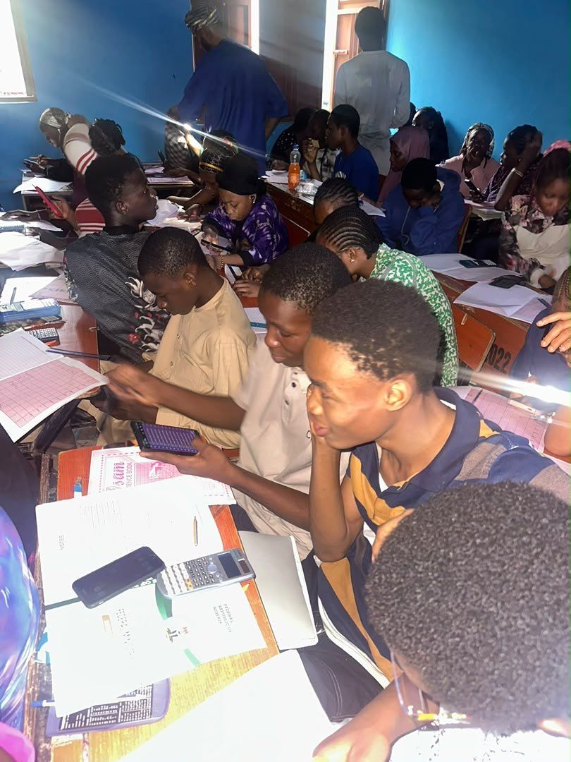 Students working through their notes at a crowded desk