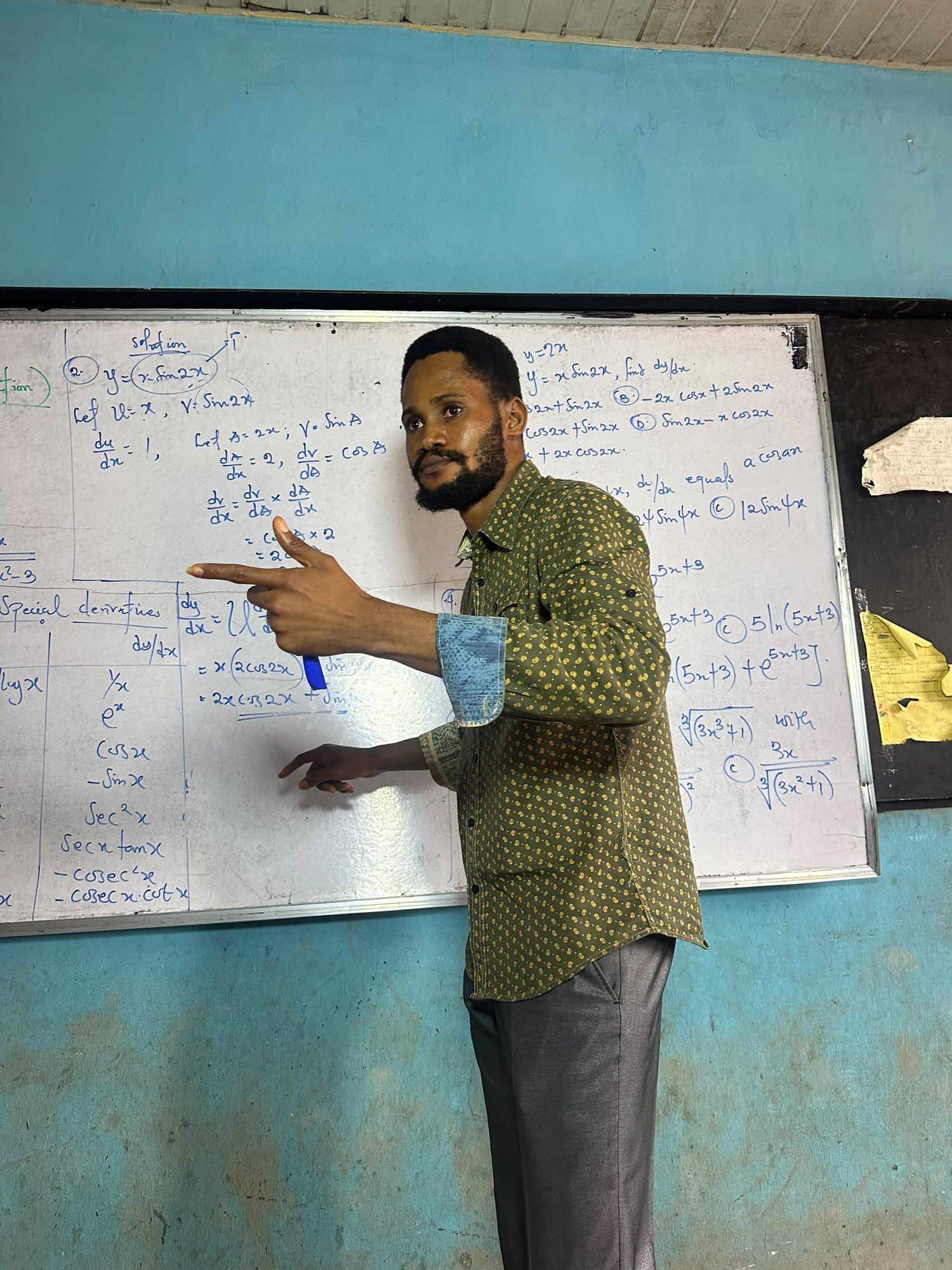 A BIA tutor pointing to working on the whiteboard