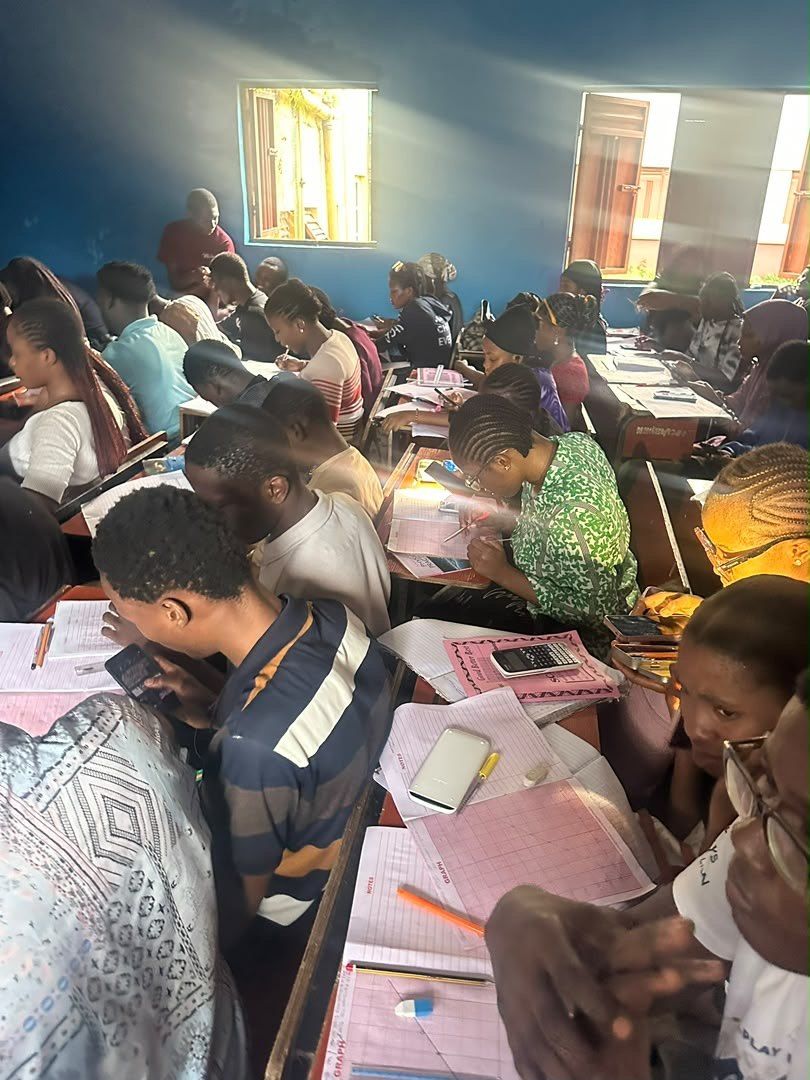 Students writing in a full classroom