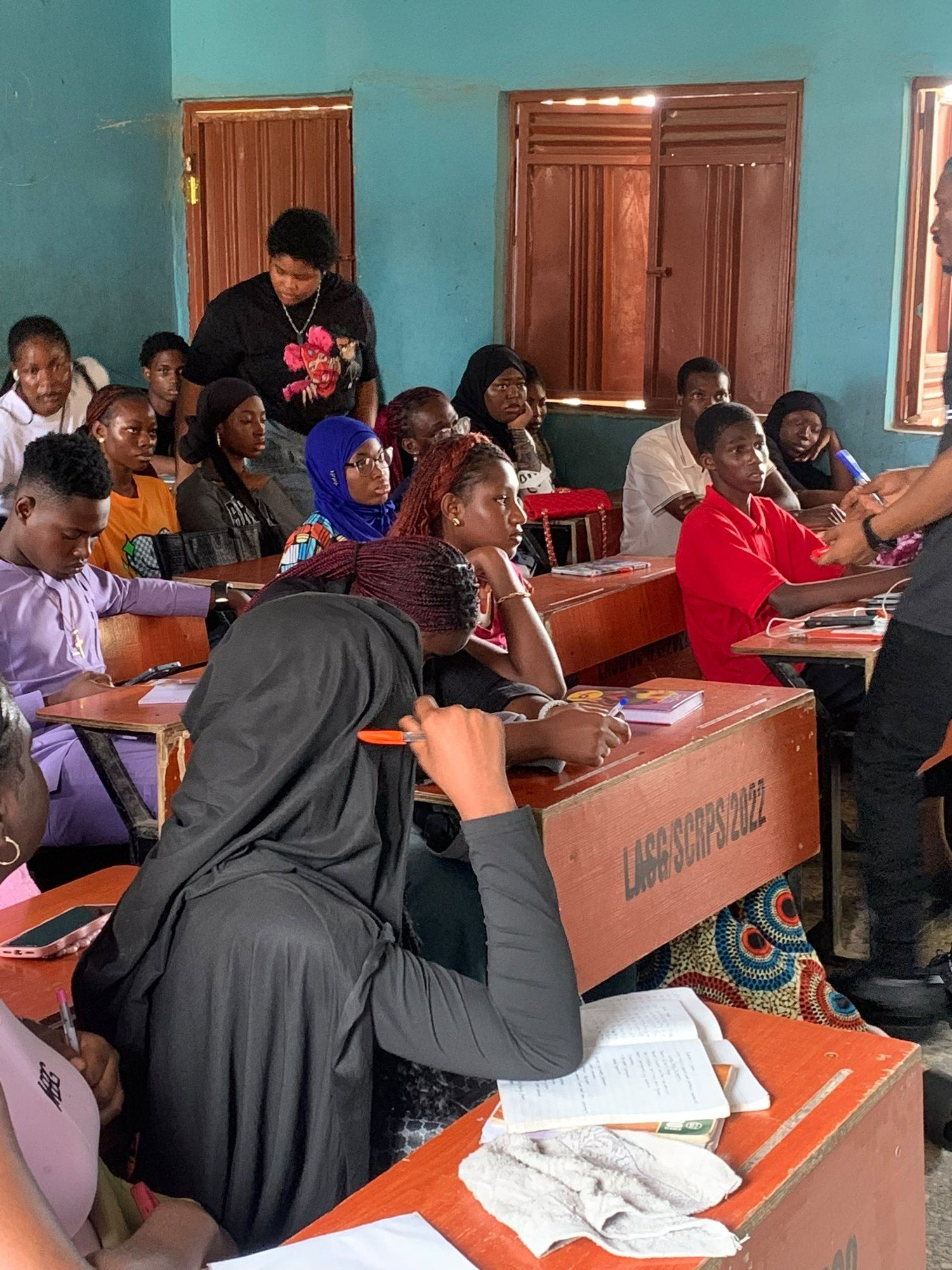 Students working at their desks, notes open