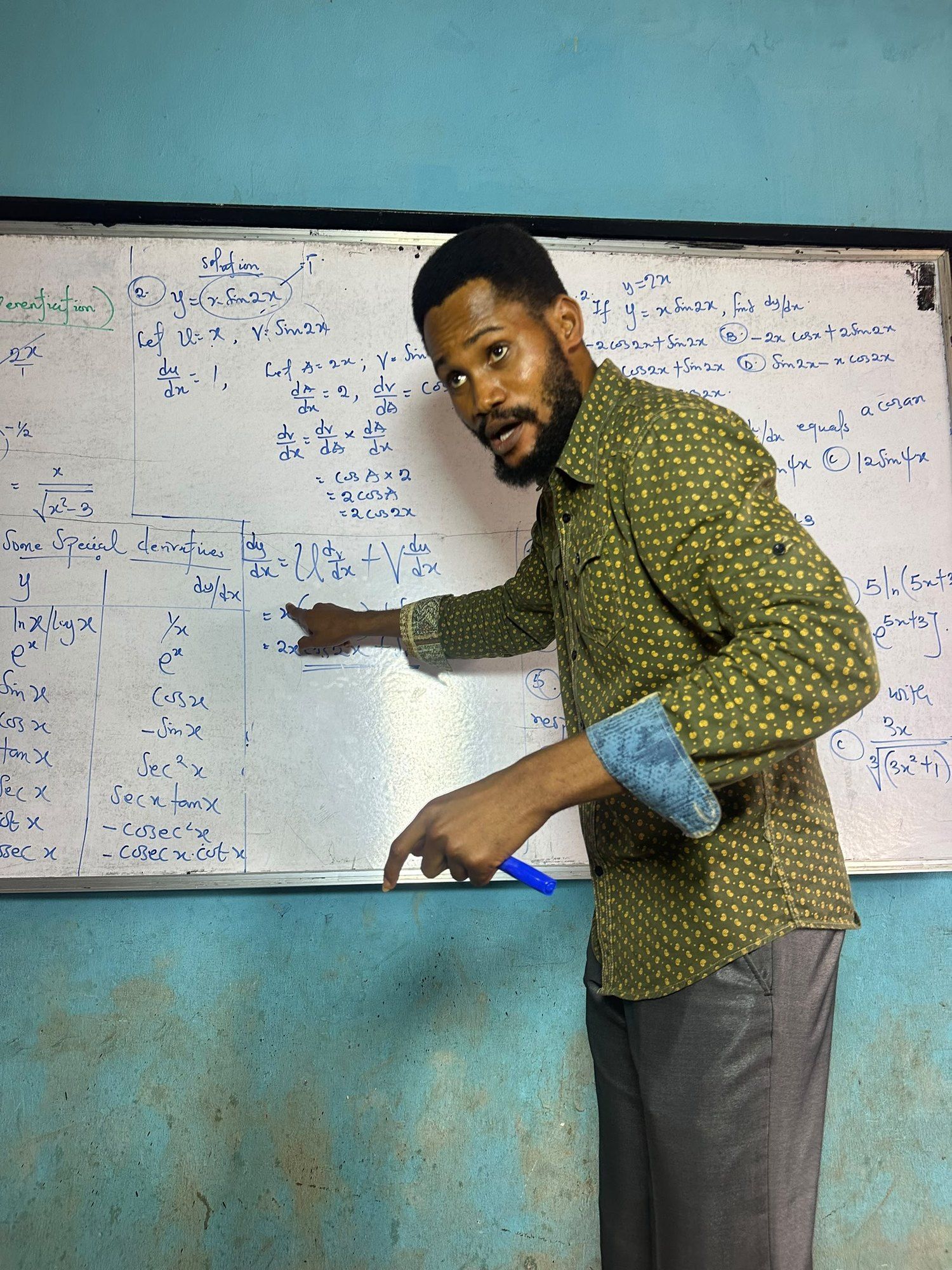 A BIA tutor explaining working on the whiteboard