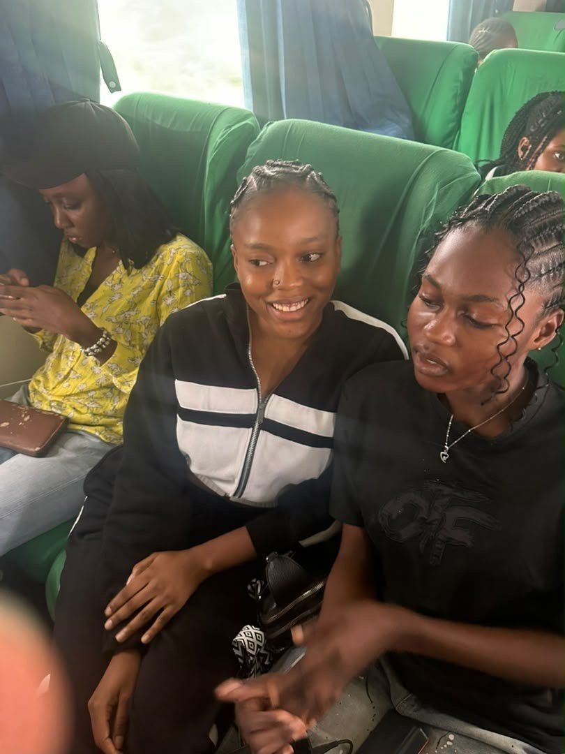 Three students sitting together on a coach