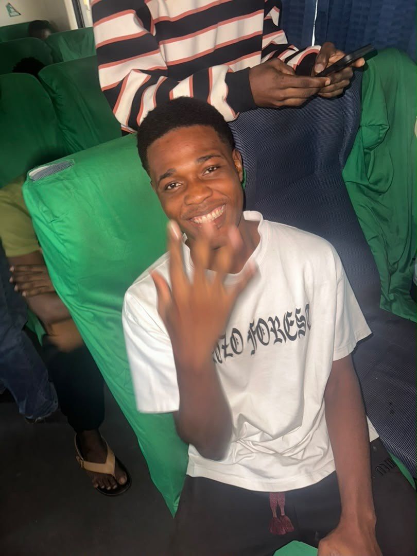 A student smiling on a coach