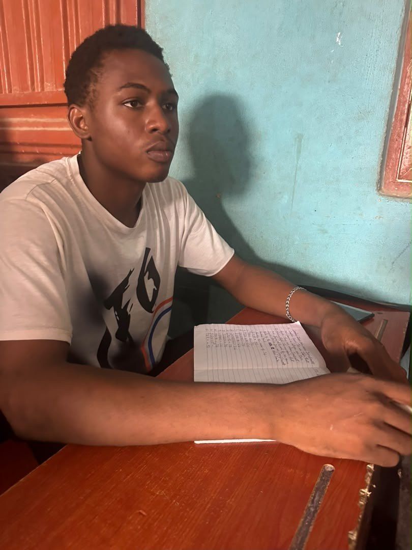 A student writing notes at a desk