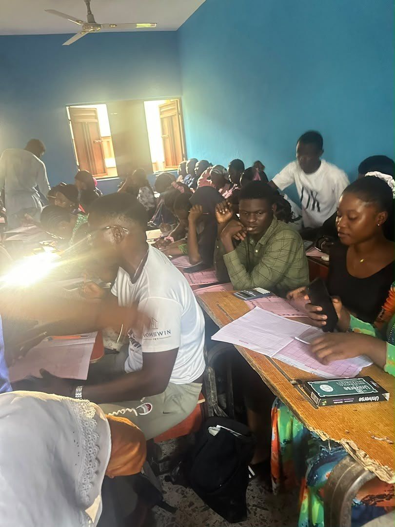 Students working at a long desk in afternoon light