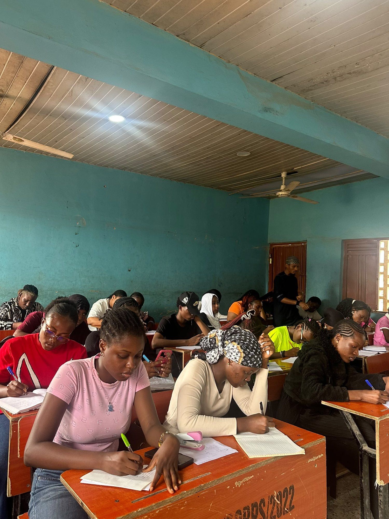 Students writing at their desks during a BIA JUPEB class